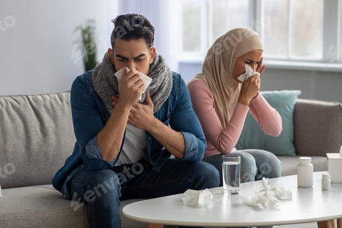 Preview: Muslim couple sneezing noses, suffering from headache