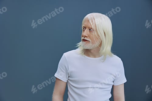Preview: elderly man with long white hair wearing a plain white t shirt against a soft blue background