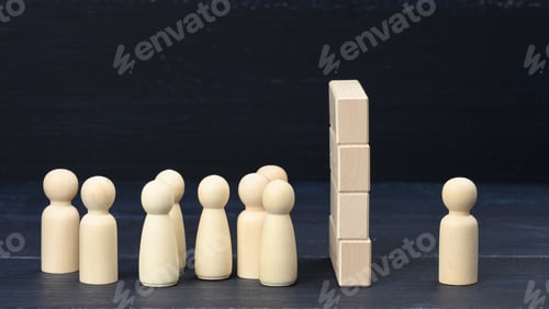 Preview: Wooden figures of men the crowd stands in front of a wall of wooden blocks