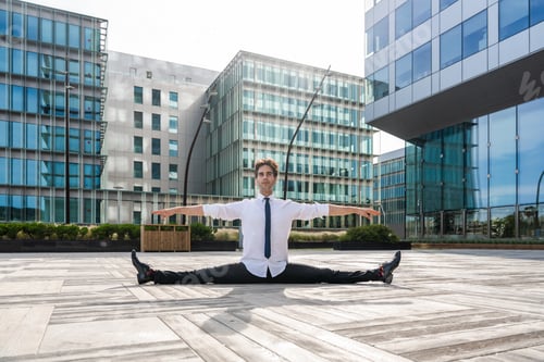 Preview: Flexible and cool businessman doing acrobatic trick