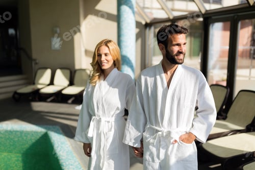 Preview: Beautiful cheerful couple relaxing in spa center