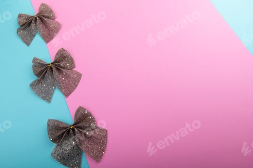Preview: Burlap bows with gold glitter on pastel color background, Christmas holiday decor