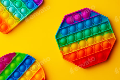 Preview: Colorful antistress pop it toy on yellow background