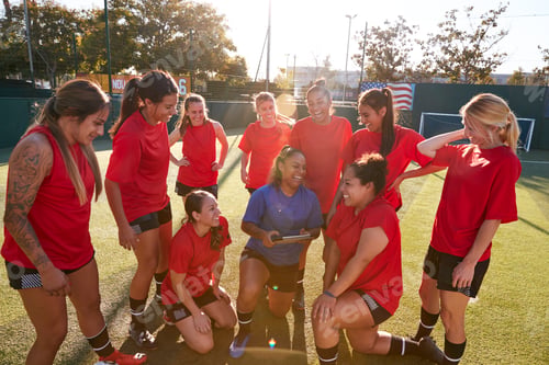 Preview: Coach With Digital Tablet Discussing Tactics With Womens Football Team Training For Soccer Match