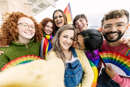 Preview: Young group of LGBT people having fun during gay pride festival party outdoors