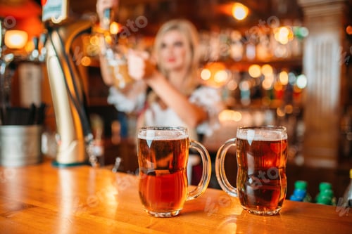 Preview: Two glasses of fresh beer on counter, octoberfest