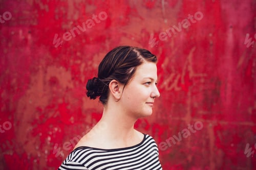 Preview: Young woman against a vibrant red textured background