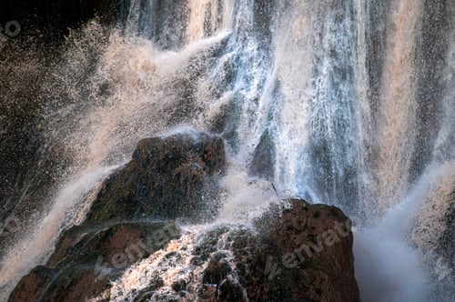 Preview: Majestic waterfalls cascade down rocky cliffs in Ouzoud, Morocco during bright daylight
