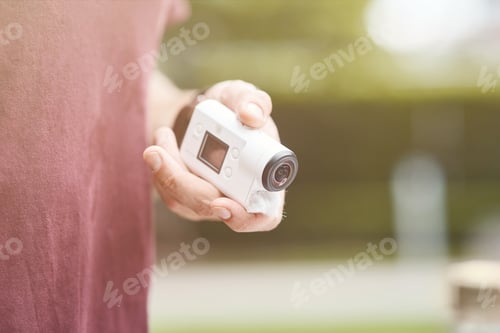Preview: Close up of action cam in hands of a pleasant man