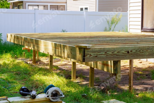 Preview: Deck construction work in garden with some torx circular saw, overlooking backyard landscape