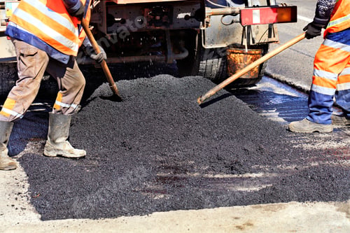 Preview: Road workers updating fresh hot asphalt with shovels and distribute it evenly over the surface