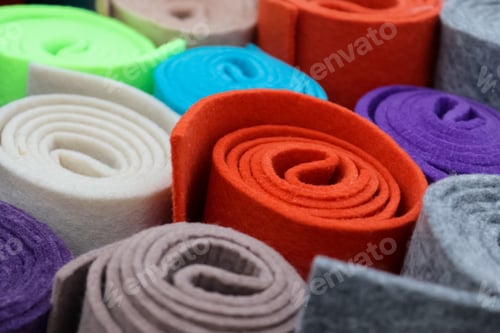 Preview: Closeup of colorful rolled felt fabrics placed next to each other