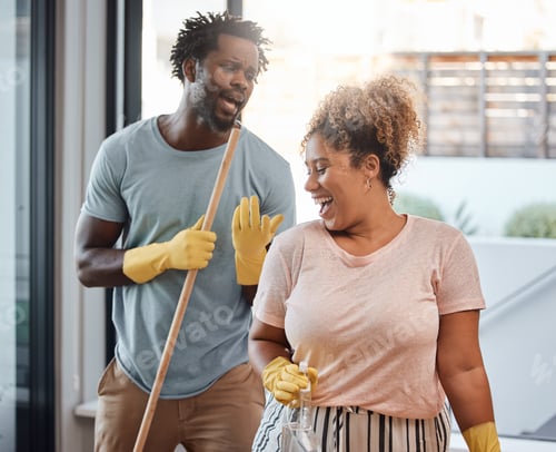 Preview: Lets turn chores into something fun. Shot of a young couple singing while cleaning at home.