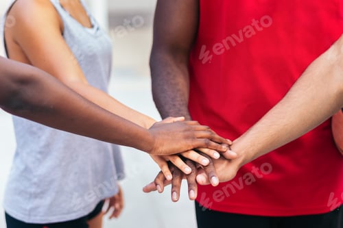 Preview: Multiracial team putting hands together before the match