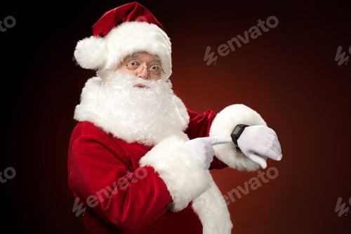 Preview: Santa Claus pointing on smart-watch, christmas coming