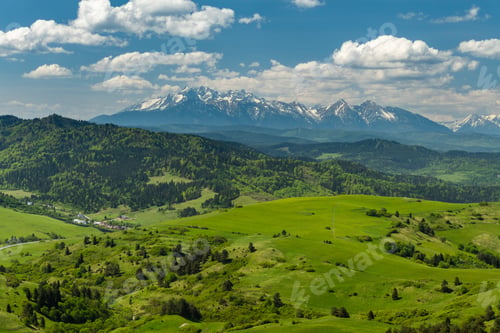 Preview: Green hills of Pieniny National Park and snowy Tatra Mountains in background in Poland