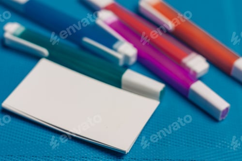 Preview: multicolored pencils and markers business cards close-up blue background