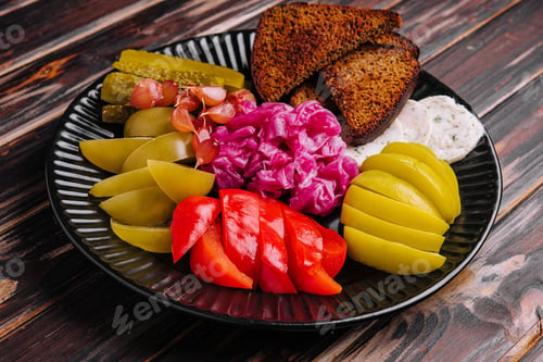 Preview: Pickles, cabbage, peppers, bread and garlic spread on a plate