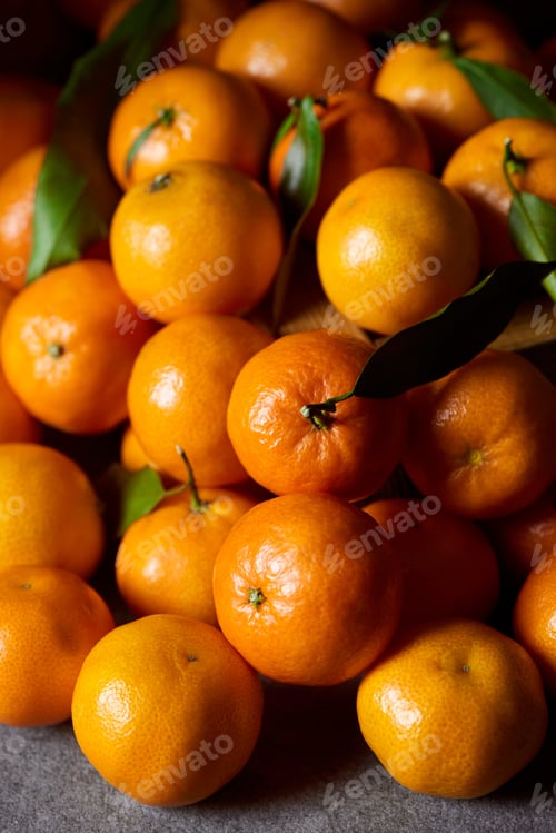 Preview: selective focus of sweet orange tangerines with green leaves