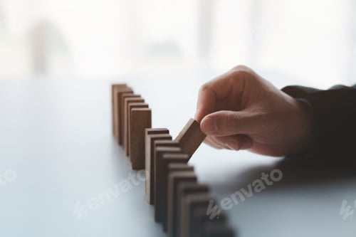 Preview: A close-up shot of a businessman holding the wooden blocks in a row.