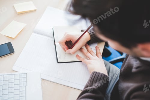 Preview: Close up man hand indoor writing agenda