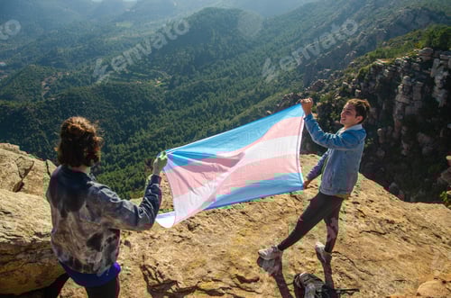 Preview: Two transgender activists holding a LGBT Flag on a mountain, Spain