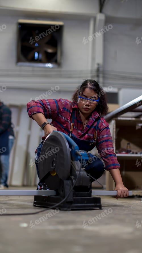 Preview: Carpenter working in carpentry shop. Carpenter working and steel cutting machine in wood workshop.