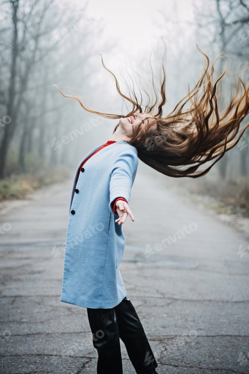 Preview: Alone Young woman with long fluttering hair express emotions in forest