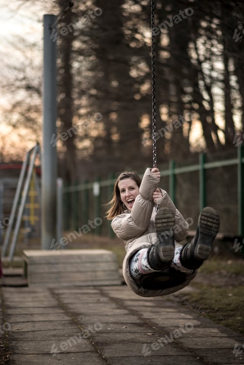 Preview: Young woman having fun on a swing
