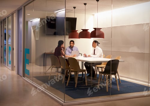 Preview: Three people in meeting cubicle at a big corporate business