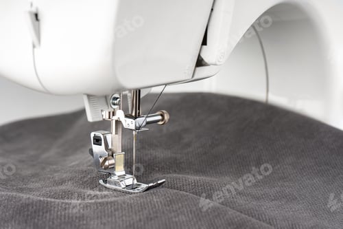 Preview: Modern sewing machine with gray fabric