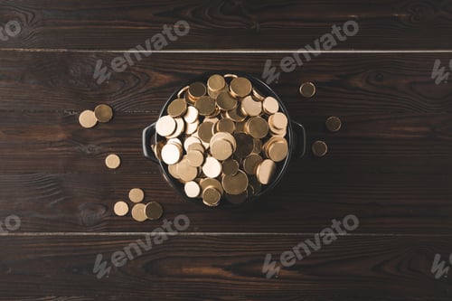 Preview: top view of pot with golden coins on wooden table, st patricks day concept