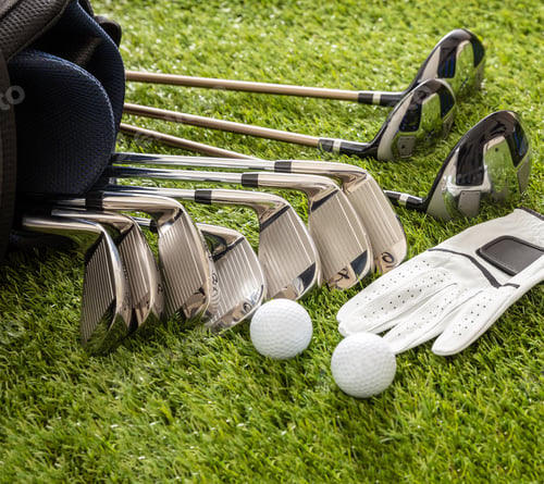 Preview: Golf equipment on green grass golf course, close up view.
