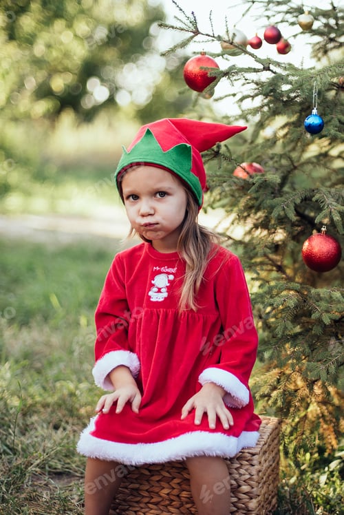 Preview: Christmas in july. Child waiting for Christmas in wood in july