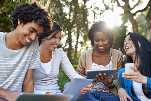 Preview: Shot of a diverse group of college students sitting outside using digital tablet