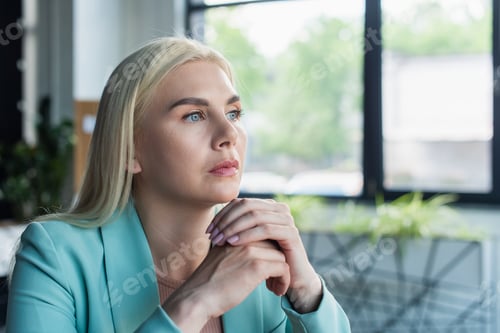 Preview: Thoughtful psychologist looking away in consultation room