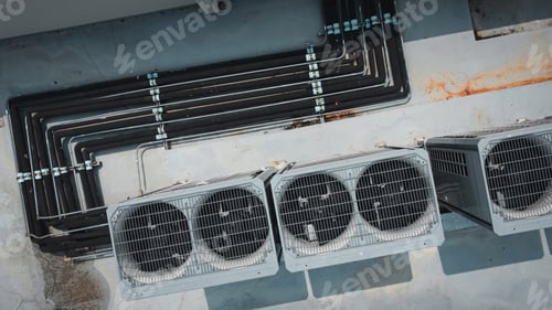 Preview: Air conditioner compressor on a building's rooftop.