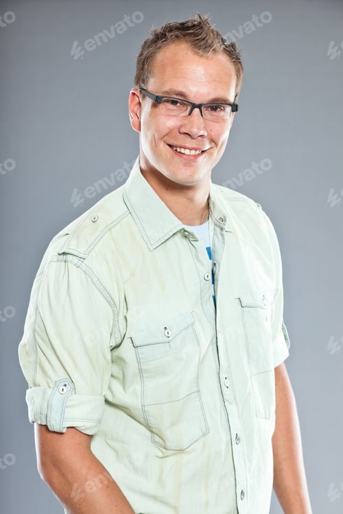 Preview: Happy Young Man With Short Hair Wearing Light Green Shirt And Blue Jeans. Wearing Glasses. Sportive