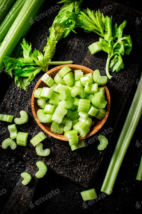 Preview: Pieces of celery in a wooden plate on the table.