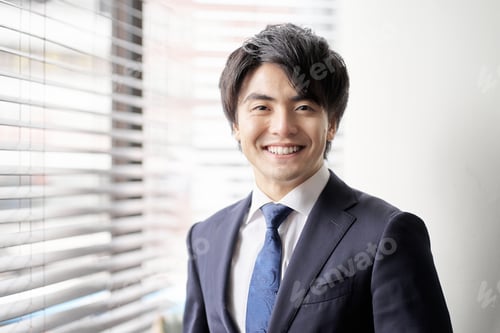 Preview: Asian businessman standing by the window