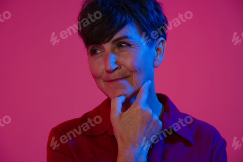 Preview: Mature european woman wearing shirt smiling and looking aside