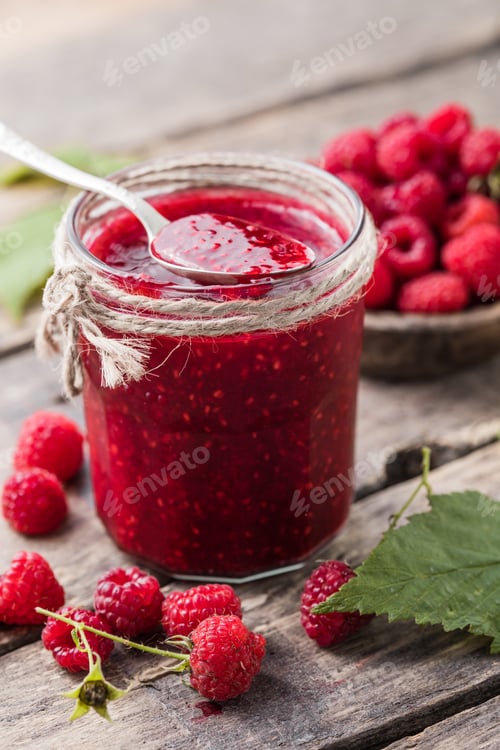 Preview: homemade raspberry jam on a wooden background with fresh raspberries, selective focus.