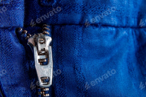 Preview: Fragment of blue jacket with metal zipper. ziplock background. Close up.