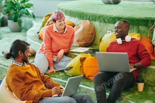 Preview: Happy young intercultural managers discussing new ideas at start-up meeting