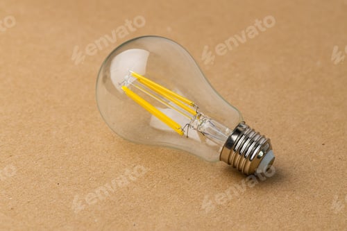 Preview: Light bulb on craft paper background close up