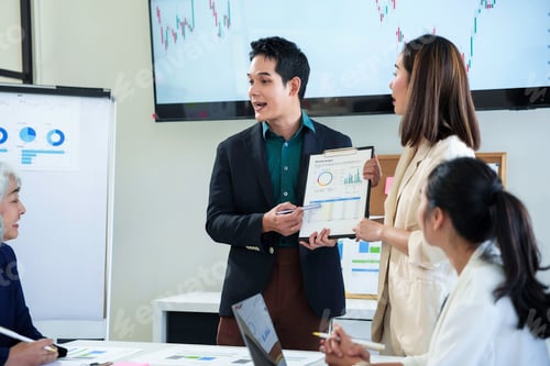 Preview: Business team analyzing financial data and discussing company strategy during a meeting