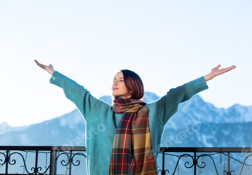 Preview: Portrait of a young redhead woman with mountains on background