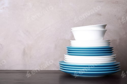 Preview: Set of dinnerware on table against grey background with space for text. Interior element