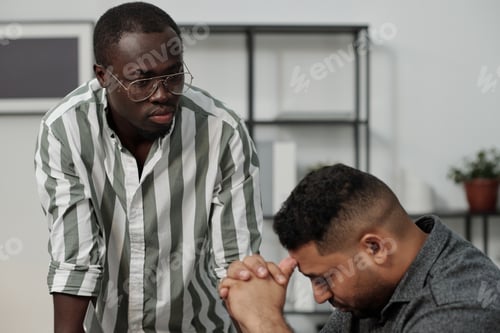 Preview: Strict boss of African ethnicity looking at Hispanic male subordinate