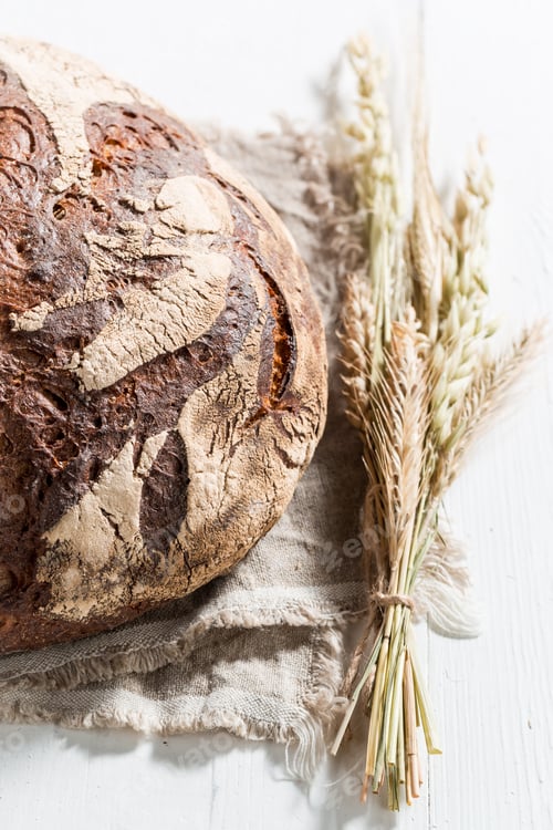Preview: Top down view of loaf of bread with several grains